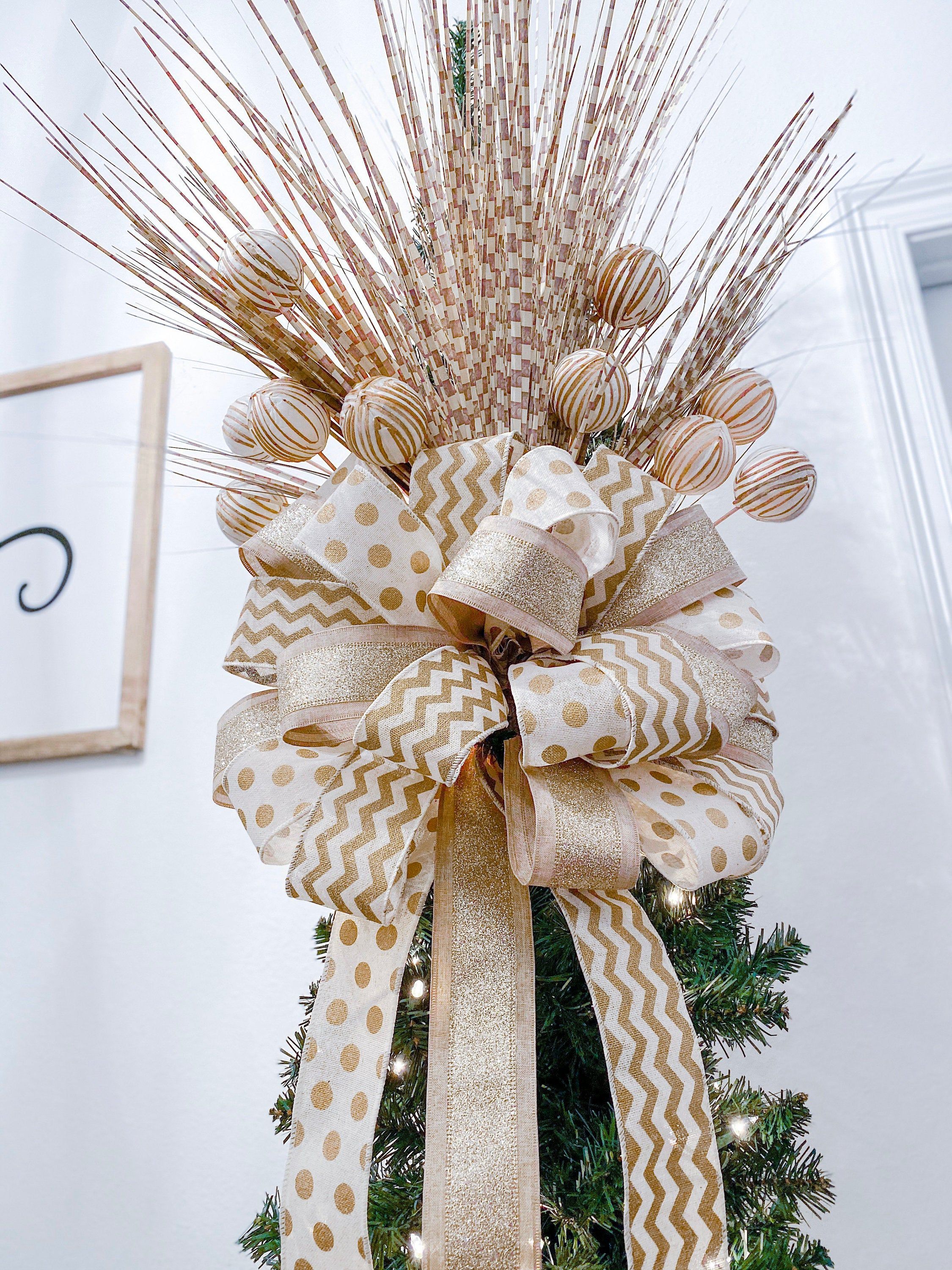 Bow-topped Christmas tree with ribbon garland