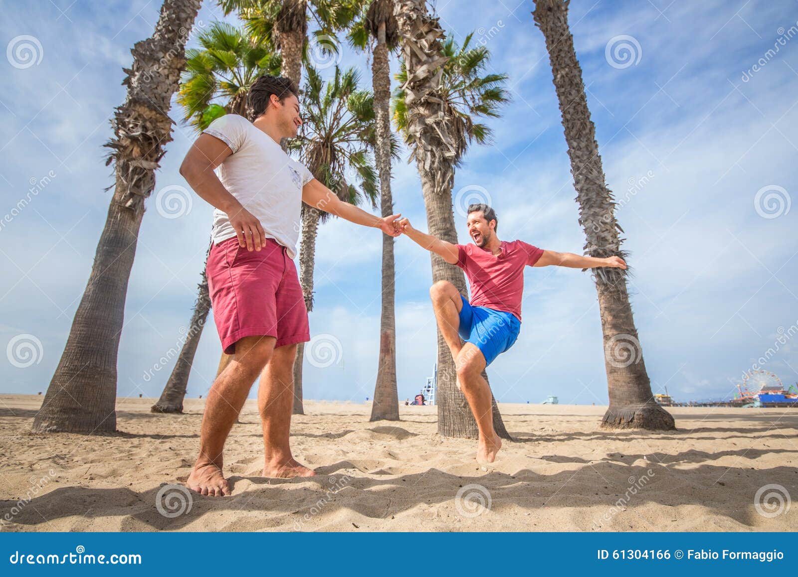 Gay couples dancing on beach