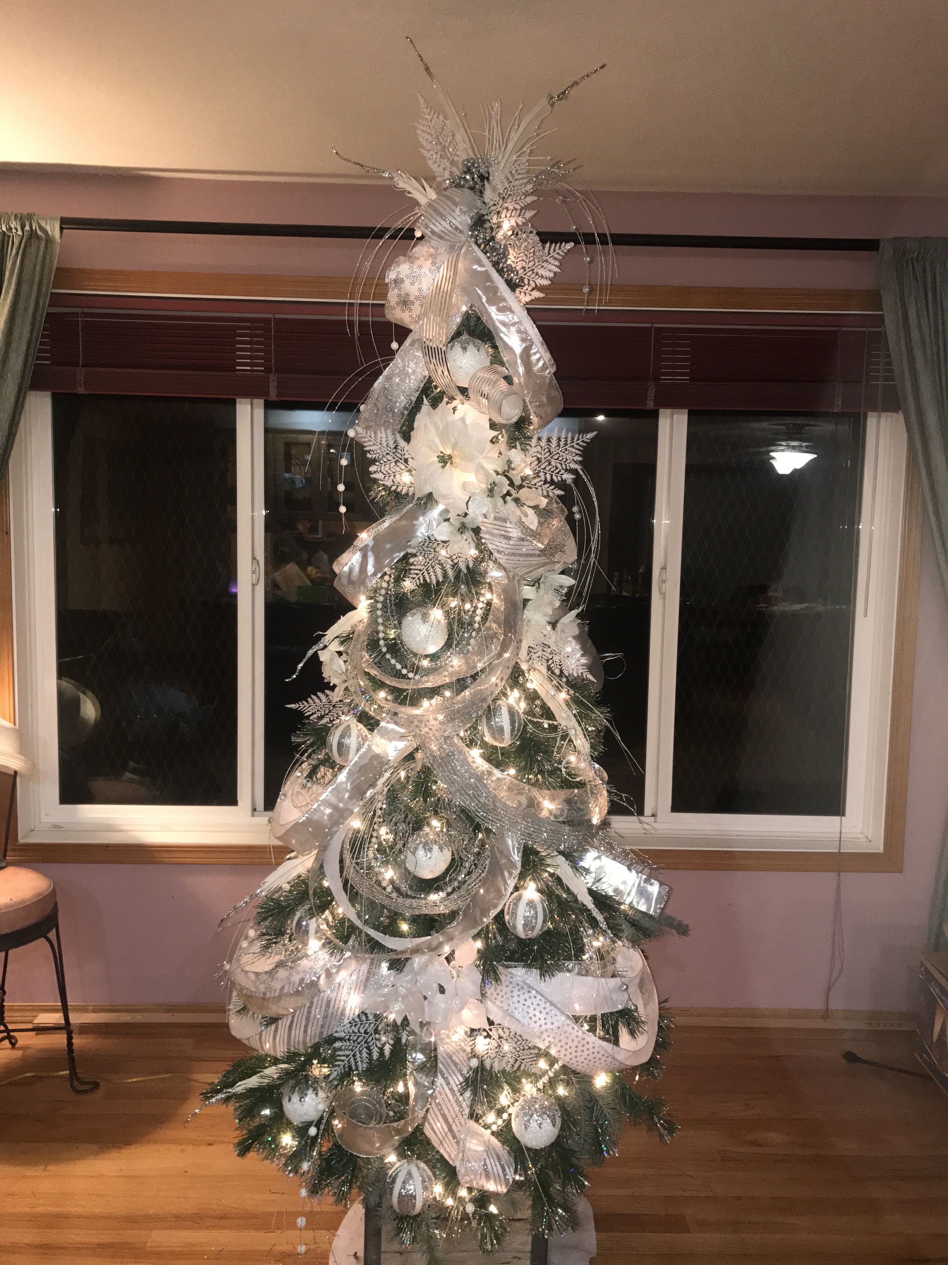 White Christmas tree with silver ribbon